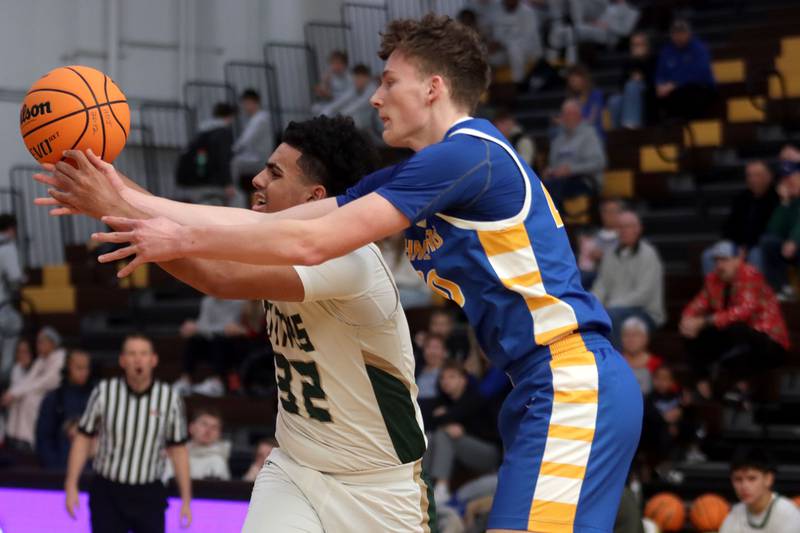 Johnsburg’s Josh Kaunas, right, tussles with Boylan’s Christian Kennedy in varsity boys basketball Hinkle Holiday Classic action on Tuesday, Dec. 23, 2025, at Jacobs High School in Algonquin.