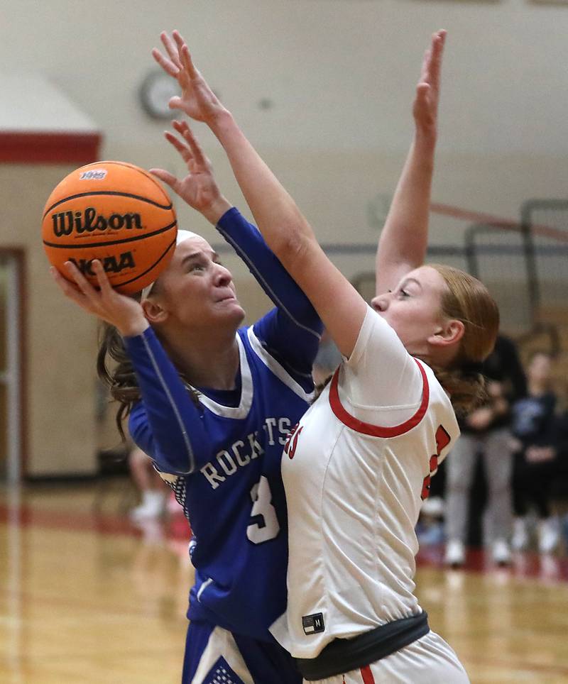 Burlington Central's Julia Scheuer tries to shoot the ball over Huntley's Avery Suess during a Fox Valley Conference girls basketball game on Tuesday Jan. 13, 2026, at Huntley High School.