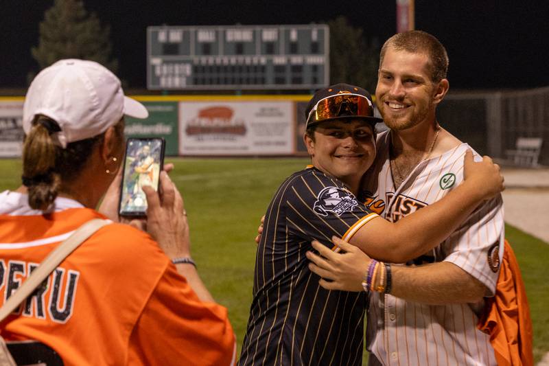 (left to right) Vicki Dorsch takes a photo of Essen McFadden embracing Tyler Dorsch of the Pistol Shrimp after the final game of the 2025 season on Thursday, July 31, 2025, at Schweickert Stadium in Peru.