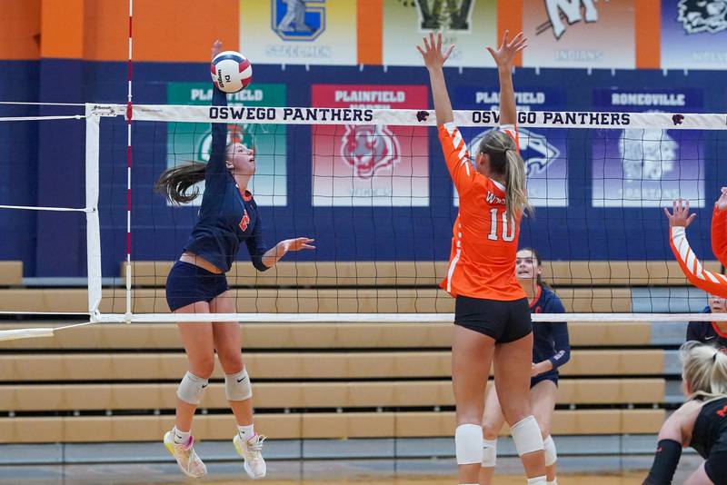 Oswego’s Kelsey Foster (2) goes up for a kill against Minooka’s Courtney Walter (10) during a volleyball match at Oswego High School on Thursday, Oct. 3, 2024.