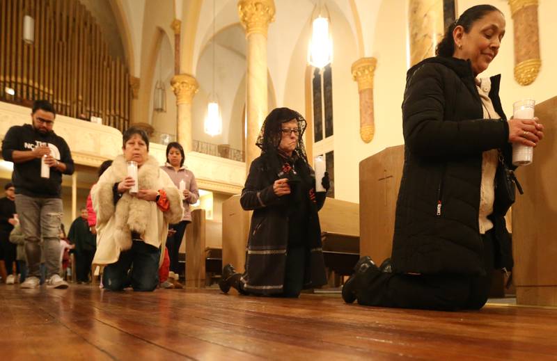 Parishioners crawl on their knees down the aisle as a way of giving thanks for prayers answered during the Lady of Guadalupe event on Tuesday, Dec. 12, 2023 at St. Hyacinth Church in La Salle. Our Lady of Guadalupe, also known as the Virgin of Guadalupe, is a Catholic title of Mary, mother of Jesus.