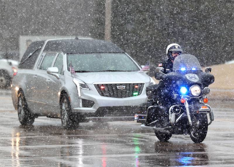 The hearse carrying the casket of former DeKalb County Sheriff Roger Scott travels down Bethany Road Friday, March 7, 2025, on its way to Fairview Park Cemetery in DeKalb following his memorial service at Bethany Road Bible Church. Scott, who was the county sheriff for 36 years, died on February 23 at the age of 78.