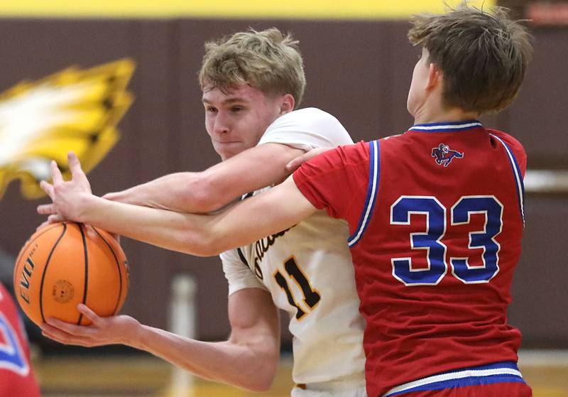 Jacobs' Carson Goehring is fouled by Dundee-Crown's Nathan Pederson during a Fox Valley Conference boys basketball game on Tuesday, February. 3, 2026, at Jacobs High School in Algonquin.
