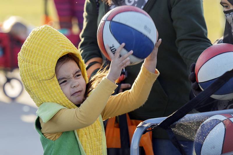 By far the corniest costume, Azalea Prince, 3, shoots hoops Friday, Oct. 25, 2024, in Rock Falls.