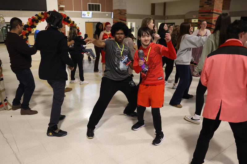 Gabriel Compton, center left, and Miko Perez show off their moves at the annual Special Population Dance hosted by Joliet West high school on Friday, March 22, 2024.