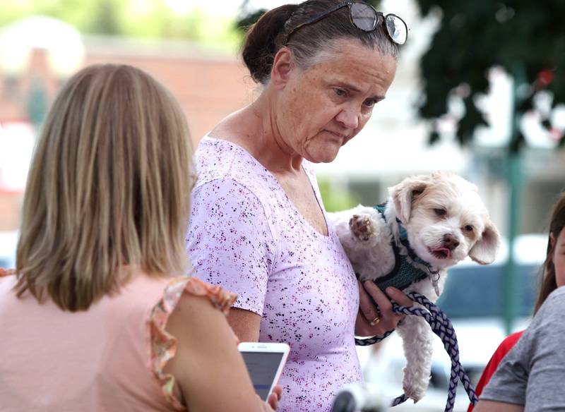 Roxanne Horton and her dog Ollie, from Sycamore, check out the items at the Petite Sweets by Cristy booth Tuesday, June 7, 2022, at the Sycamore Farmers Market on the lawn of the DeKalb County Courthouse.