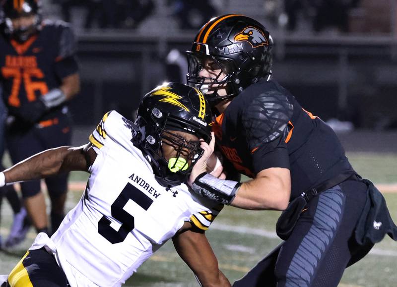 DeKalb's Cole Latimer runs through Andrew’s Jeremyah Johnson on his way to the endzone during their game Friday, Oct. 16, 2025, at DeKalb High School.