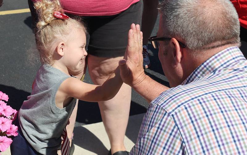 Darren Bailey, a Republican candidate for Illinois governor, gets a high five from Charlie Flammand, 2, from DeKalb Friday, June 17, 2022, during his campaign stop at Tom and Jerry's in Sycamore. Bailey is currently on a bus tour across the state that will cover 102 countys in 14 days.