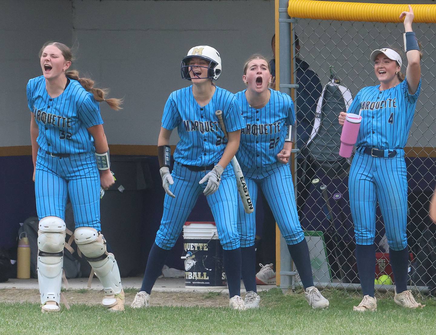 Marquette players (from left) Kelsey Cuchra, Taylor Gamons, Kinley Rick and Hunter Hopkins react after scoring the teams first run during the Class 1A Regional title game on Friday, May 22, 2026 at Serena High School.