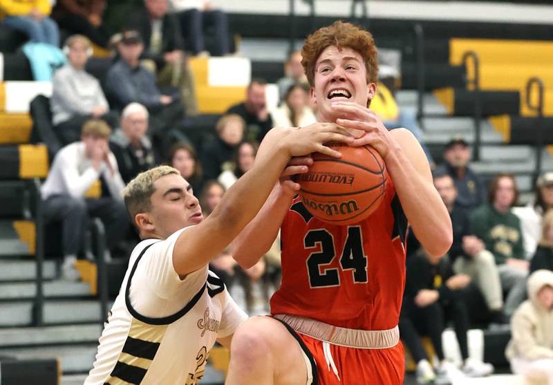 Sycamore's Diego Garcia gets a hand on the ball as Sandwich's Dom Rome goes to the basket during their game Friday, Nov. 24, 2023, in the Leland G. Strombom Holiday Tournament at Sycamore High School.