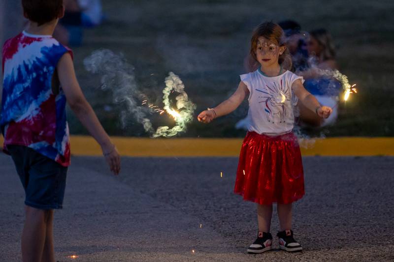 Harley plays with sparklers at the annual 4th of July firework show on Friday, July 4, 2025 at River Front Park in Hennepin.
