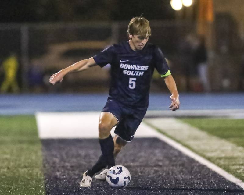 Downers Grove South's Brady Dunlap (5) dribbles the ball during soccer match between Downers Grove North at Downers Grove South. Oct 2, 2025.