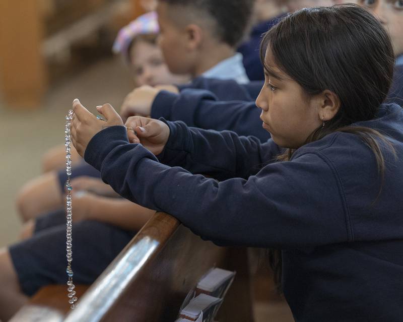 St. Anne’s student Jocelyn Juarez prays the rosary Wednesday, April 23, 2025, with her classmates. Students, staff and parishioners were invited in to pray for the recently deceased Pope Francis.