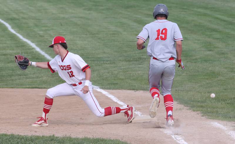 Streator's Cooper Spears misses a throw at first base as Ottawa's Payton Knoll reaches the bag safely on Tuesday, May 16, 2023 at Streator High School.