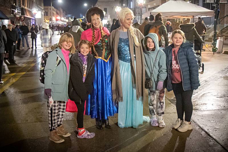 Anna and Elsa pose with Justice Lance (left), 10, Ivy Sullivan, 9, Madi Hall, 10, and Maci McCall, 9, during the Dixon Christmas walk Friday, Dec. 1, 2023.