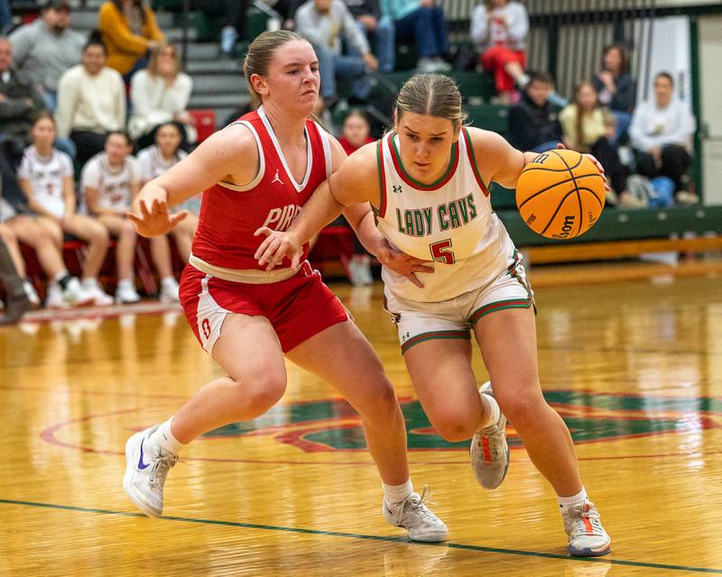 Emma Jereb (5) of LaSalle-Peru dribbles ball as Kennedy Kane (24) of Ottawa guards at hip on Wednesday, December 17, 2025 at Sellet Gymnasium in LaSalle.