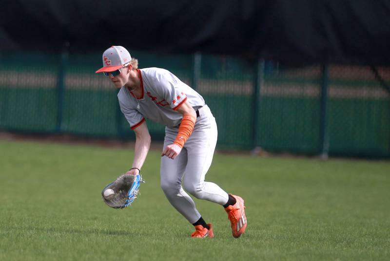 St. Charles East's Joey Arend scoops up a ground ball during a game against Wheaton North on Wednesday, April 23, 2025 in St. Charles.