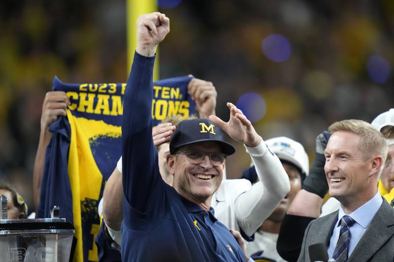 Michigan head coach Jim Harbaugh celebrates after the Big Ten championship game against Iowa, Saturday, Dec. 2, 2023, in Indianapolis.