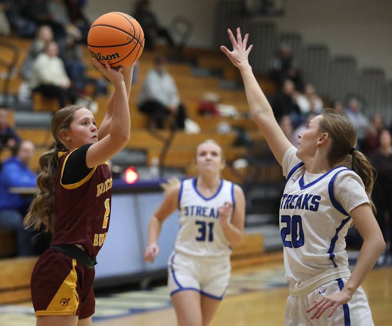 Richmond-Burton's Cambrie Lindholm shoots the ball over Woodstock's Kendall O'Dea during a Kishwaukee River Conference girls basketball game on Wednesday, Jan. 28, 2026, at Woodstock High School.
