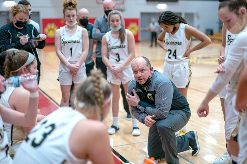 Sycamore's head coach Adam Wickness talks to his players during a break in play against Hampshire during the Batavia MLK Showdown at Batavia High School on Monday, Jan 17, 2022.