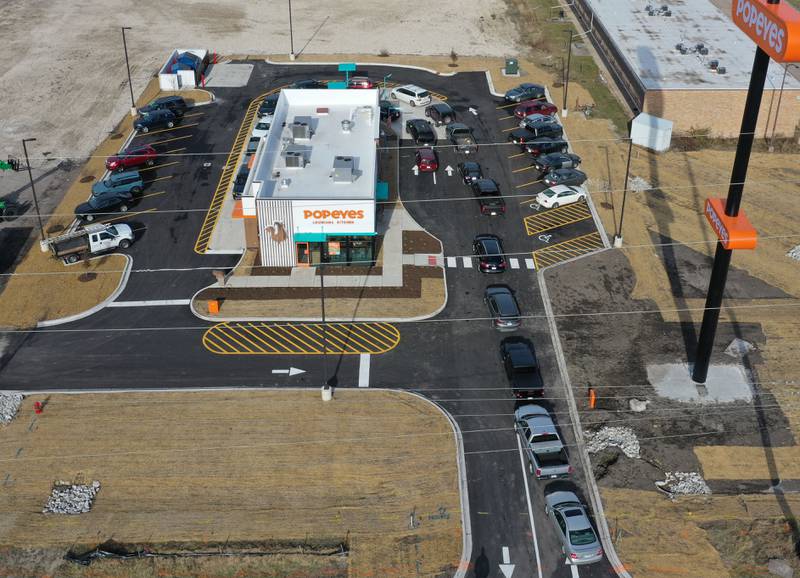 A long line of vehicles is backed up onto May Road for the opening of Popeyes on Monday, Dec. 9, 2024. The franchise opened their doors on Friday.