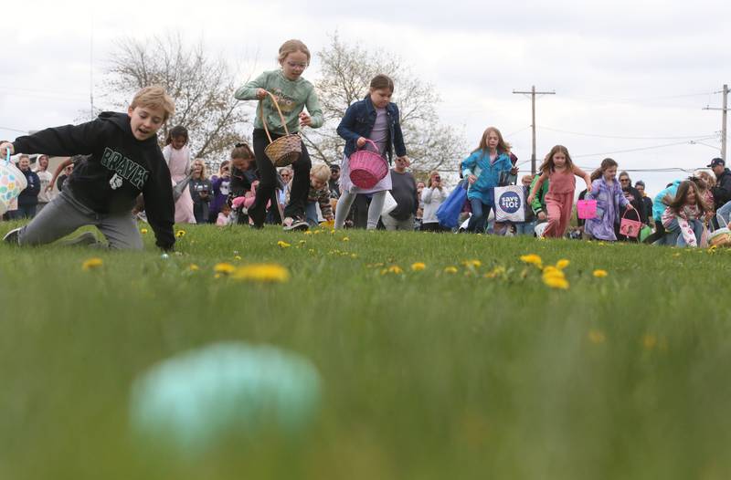 Kids scramble to collect Easter eggs during the annual Easter egg hunt on Saturday, April 19, 225 at Carey Memorial Park in Utica. This year marks the first time the Utica Fire Department used plastic eggs since the 1970's when the hunts began. The fire department chose plastic eggs this year instead of dying them due to the high cost and quantity.