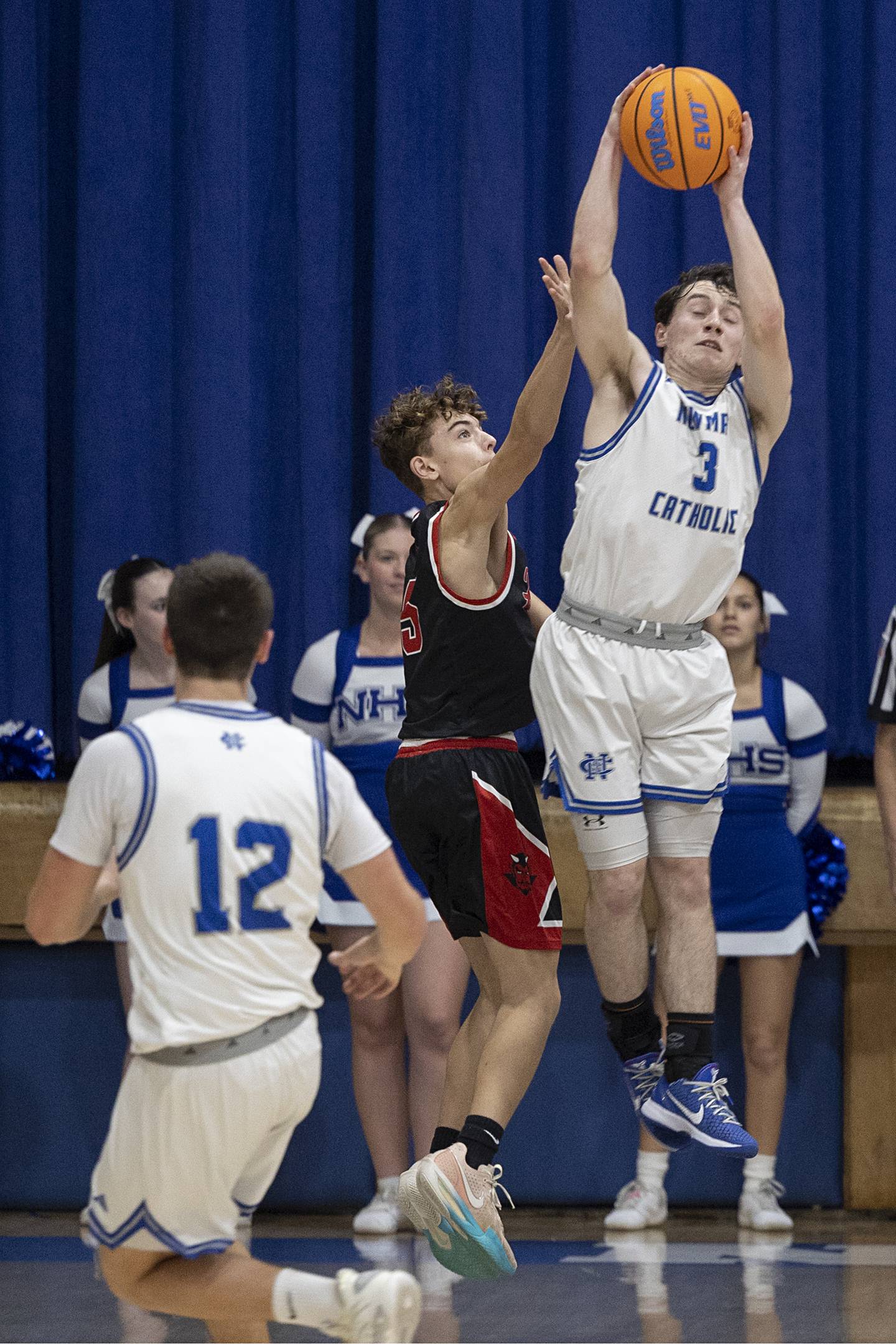 Newman’s Garret Matznick steals pass against Hall Tuesday, Feb. 17, 2026.