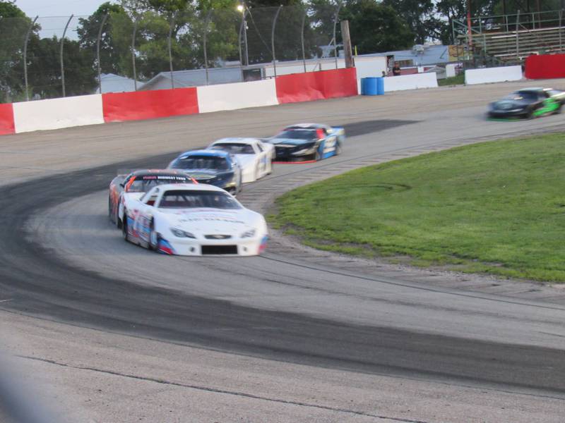 Cars race around the track at the Grundy County Speedway.