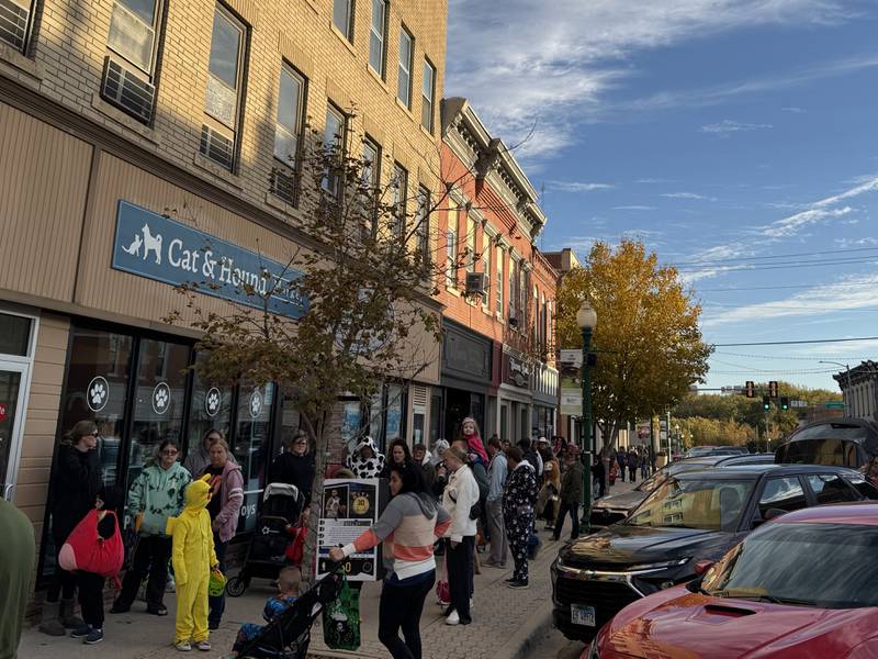 Children and parents line up down Liberty Street in Morris Thursday, Oct. 30 for the Downtown Trick or Treat.