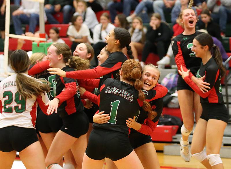 L-P's Addison Dutlinger (1) hugs teammate Kaylee Abens while teammates react after defeating Morris in the  Class 3A Regional game on Thursday, Oct. 26, 2023 at Sellett Gymnasium.