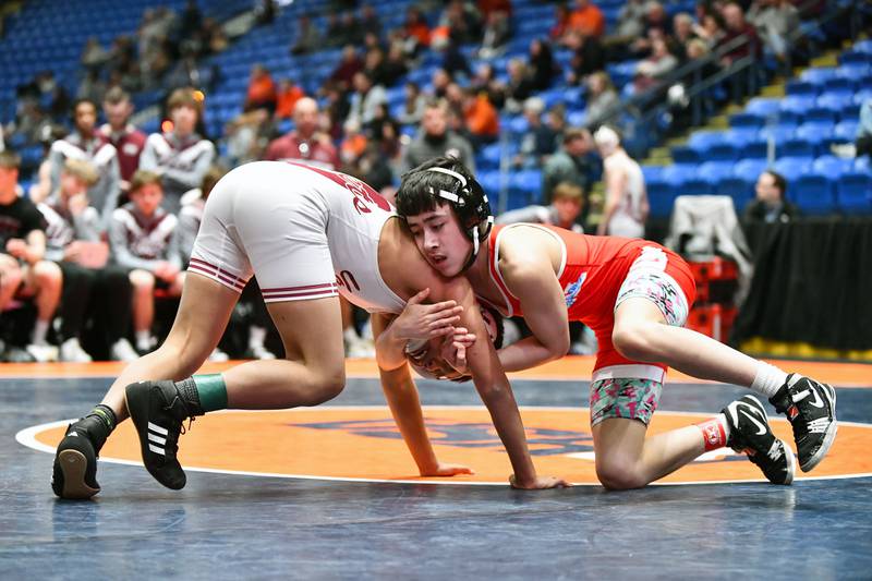 Diego Martinez of Marian wrestles Vince Abon of Tolono Unity in the 106-pound match during the IHSA Dual Team State Finals in Bloomington on Saturday, March 1.