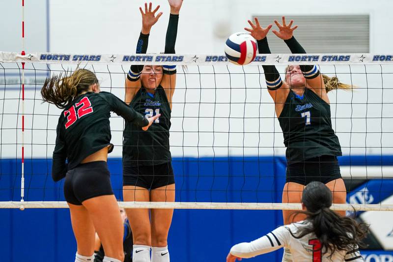 St. Charles North's Mia McCall (7) blocks a kill attempt by Huntley’s Izzy Whitehouse (32) during a non-conference match at St. Charles North High School on Wednesday, Sept. 3, 2025.