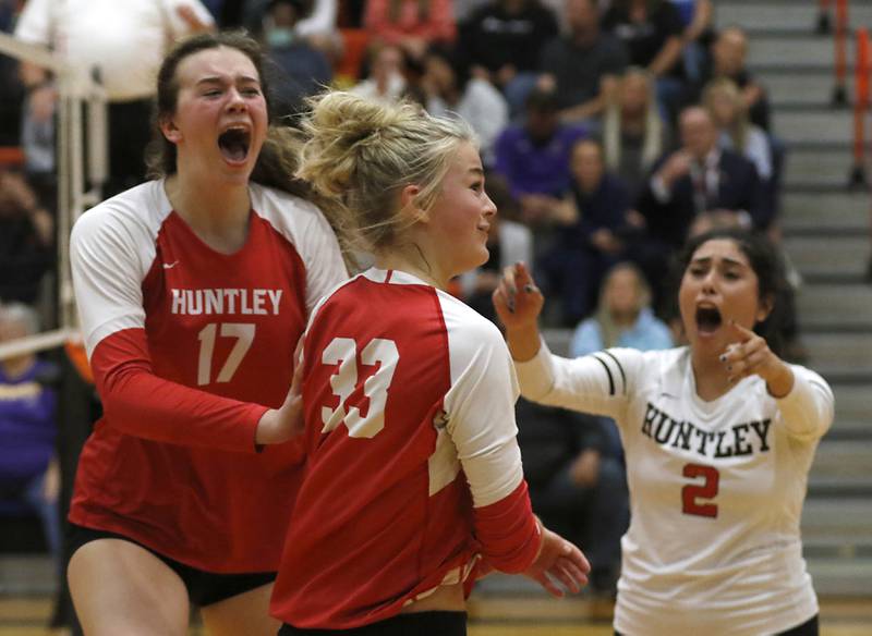 Huntley's Georgia Watson, left and Luma Acevedo, right, react to spike of Allyson Panzloff, center, during the IHSA Class 4A Harlem Sectional Championship volleyball match Wednesday, Nov. 2, 2022, between Huntley and Hononegah at Harlem High School in Machesney Park.