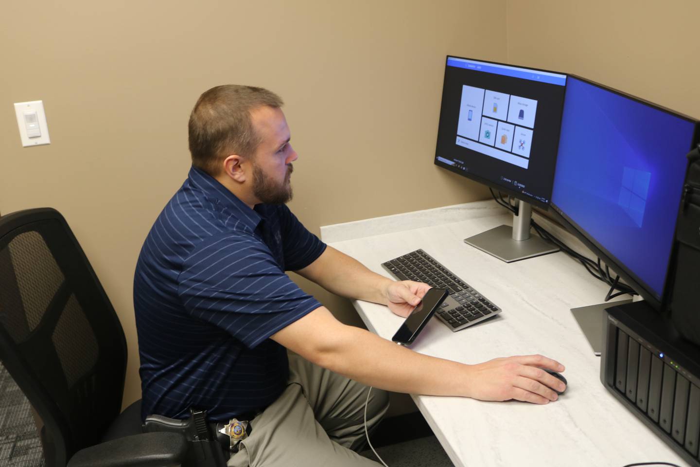 McHenry Detective Matt Voelker, seen here on Thursday, Nov, 10, 2022, shows how software recently purchased through an agreement between the city of McHenry and the McHenry County State's Attorney's office can help investigators get important information off of cell phones.