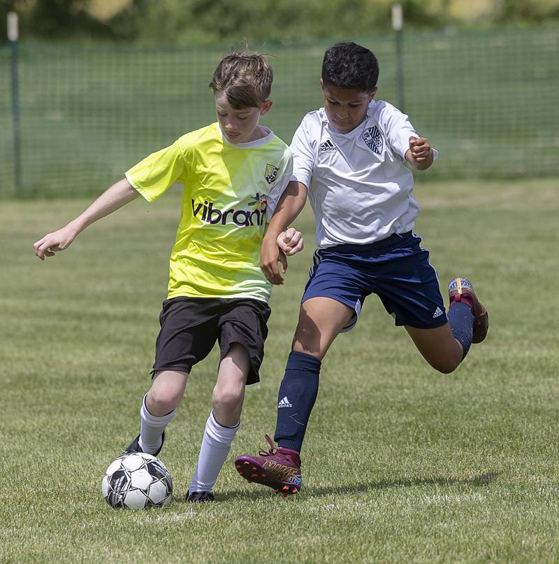 Sterling United’s Jaden Miller (right) works against a Quad City Strikers player Sunday, May 19, 2024 at Scheid Park in Sterling.