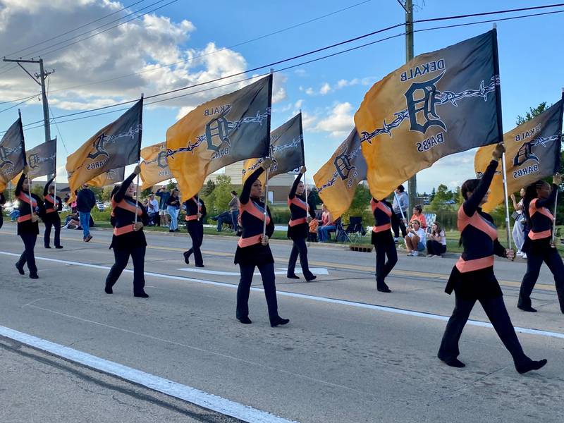 Flag-bearers hoist the Barb spirit high to start off the annual DeKalb High School Homecoming Parade on Wednesday, Sept. 24, 2025, along West Dresser Road.
