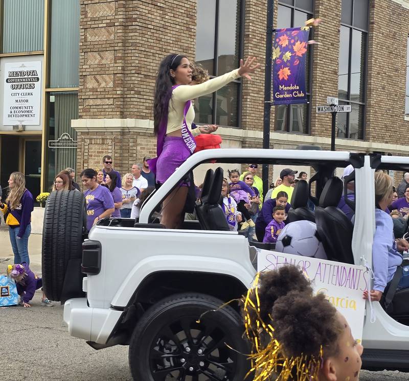 Mendota High School homecoming senior attendant Crystal Garcia tosses candy to the crowd Friday, Sept. 27, 2024, during the homecoming parade.