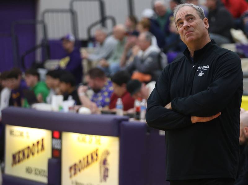 Ottawa head basketball coach Mark Cooper glances at the scoreboard while playing Mendota on Tuesday, Jan. 6, 2026 at Mendota High School. Cooper, a Mendota alumni is in his last season as head coach for the Pirates.