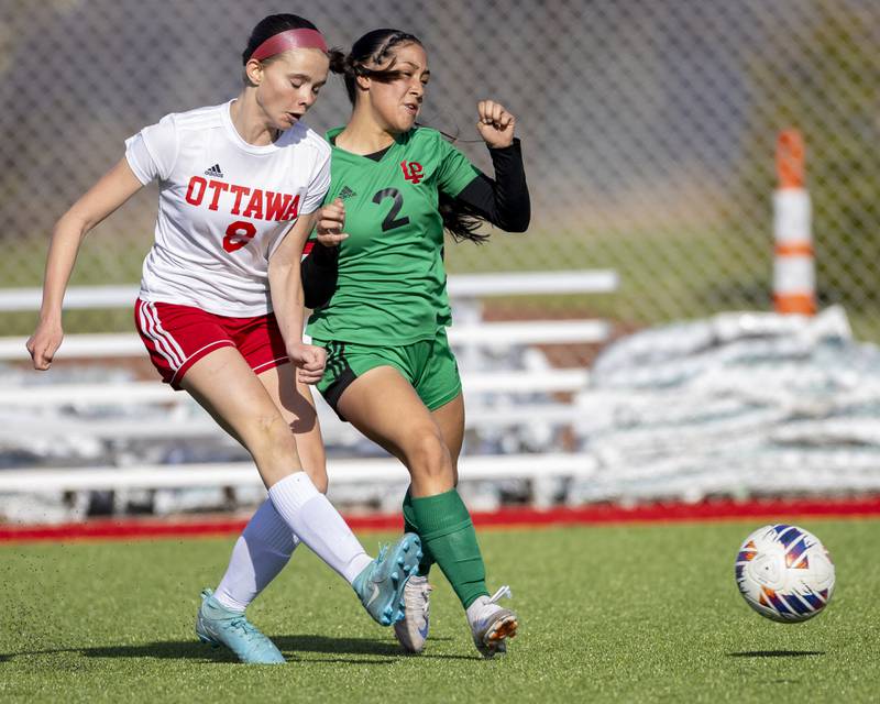 Vicky Tejada of LaSalle-Peru High School battles Georgia Kirkpatrick of Ottawa High 
School during the match on April 10, 2025 at the LaSalle-Peru Sports Complex.