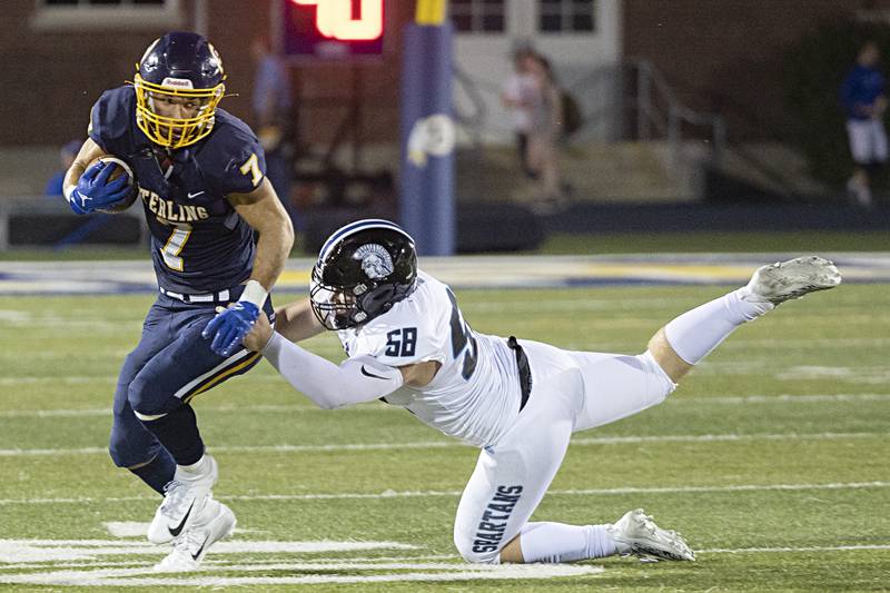 Sterling’s Andre Klaver breaks a tackle against St. Francis’ Brady Hill Friday, Sept. 1, 2023 at Sterling High School.