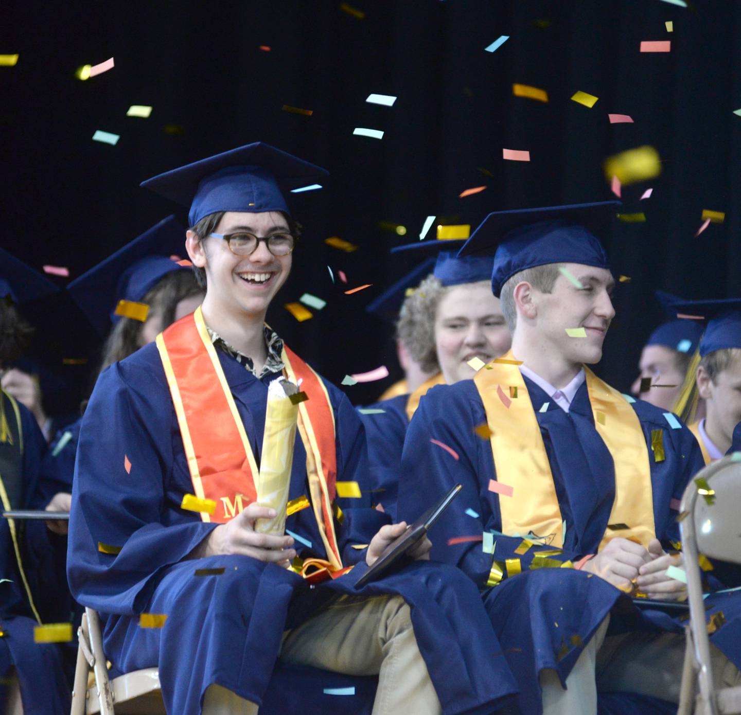 Logan Hudson and Waylon Harris smile as confetti falls on them at the close of Polo High School's commencement on Sunday, May 21.
