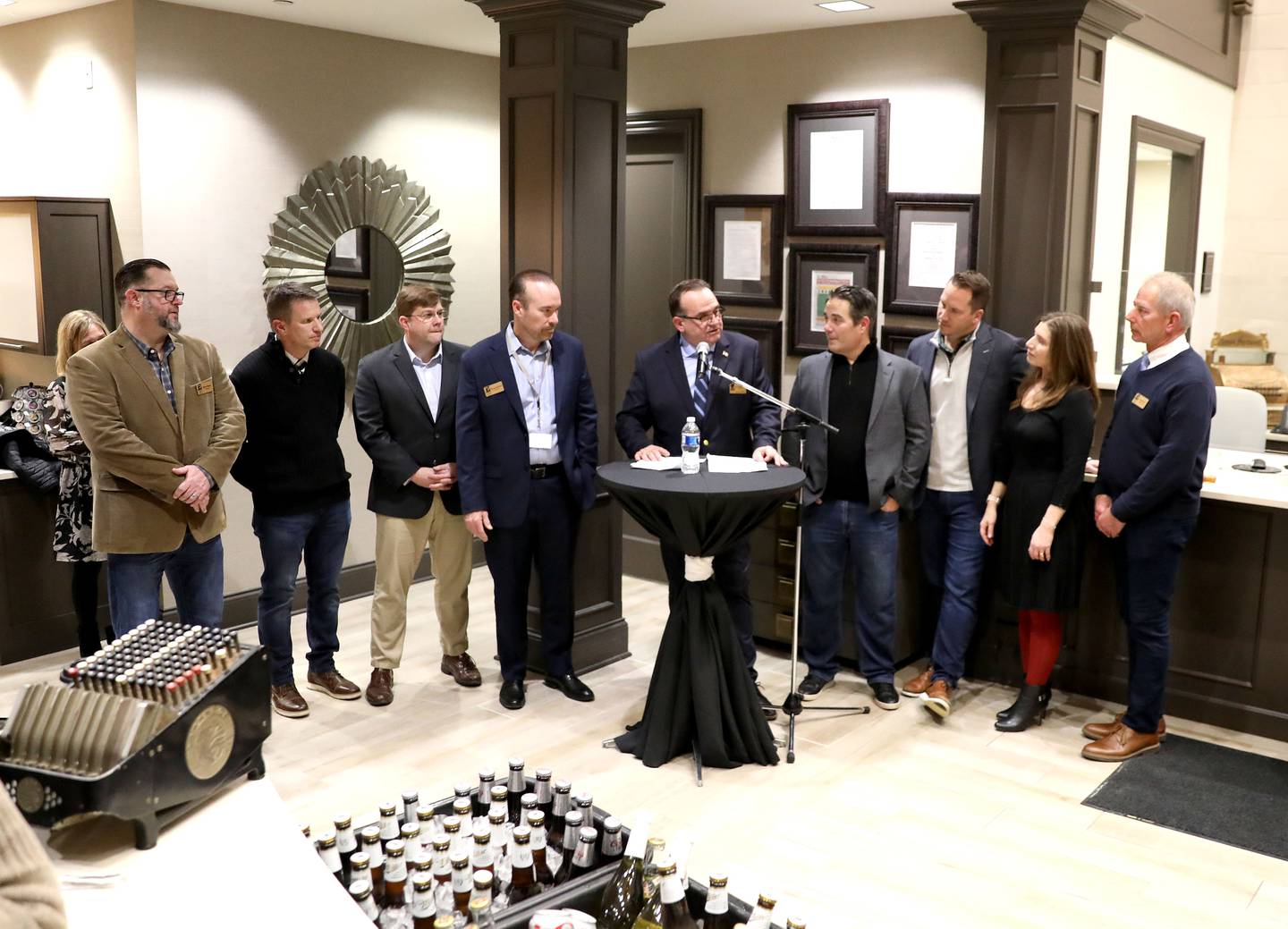 St. Charles Alderperson Ed Bessner (center), who chairs the St. Charles Initiative, introduces the city council during a dedication ceremony for the First Street Plaza expansion project at Sterling Bank in St. Charles on Wednesday, Jan. 24, 2024.