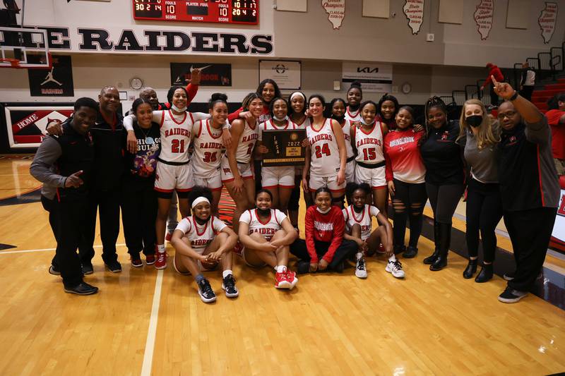 Bolingbrook poses with the championship plaque after their 61-50 win over Homewood-Flossmoor in the Class 4A Bolingbrook Sectional championship. Thursday, Feb. 24, 2022, in Bolingbrook.