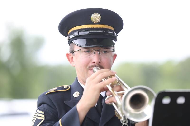 A trumpeter performs with the IL Army National Guard’s 144th Army Band during the National Cemetery Administration 50th Anniversary ceremony at the Abraham Lincoln National Cemetery in Elwood on Saturday, July 29.