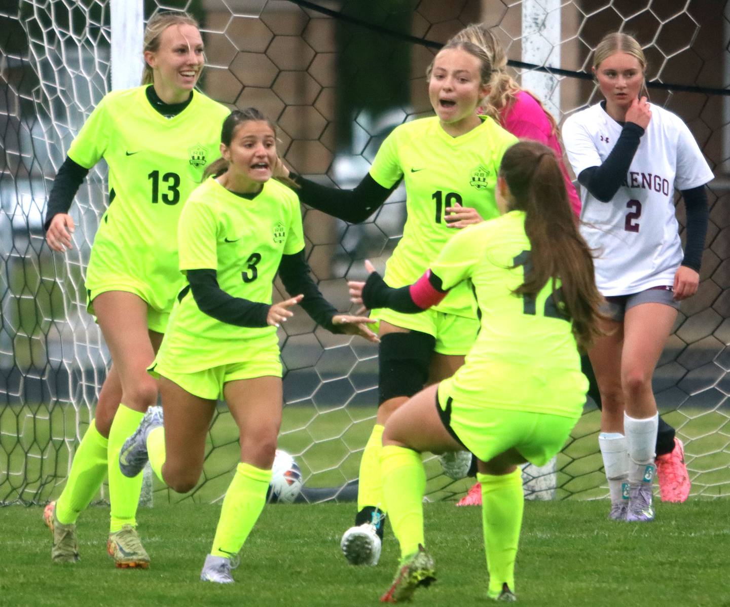 Richmond-Burton’s Rockets celebrate a goal by McKenzie Ragusca, center left, in IHSA Class 1A Regional Title Game action soccer at Marengo High School in Marengo on Wednesday, May 21, 2025.