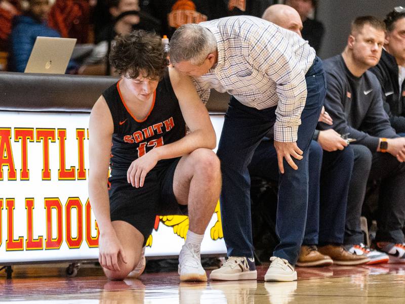 Wheaton Warrenville South Head Coach Mike talks to player Caden Heintzelman before he was subbed into an away game against Batavia on Tuesday, Jan. 7, 2025.
