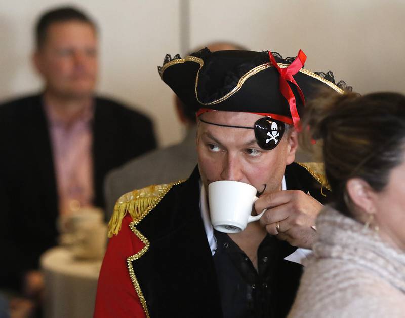 Bryan Younge, the president of Crystal Lake Parks Initiative Foundation, sips a cup of coffee while dressed as a pirate to advertise the Crystal Lake Cardboard Regatta during the Crystal Lake Chamber of Commerce’s State of the Community Luncheon, Friday, Feb. 4, 2022, at D'Andrea Banquets & Conference Center. The annual luncheon feature guest speakers Crystal Lake Mayor Haig Haleblian and Village of Lakewood President David Stavropoulos who spoke about their respective communities.