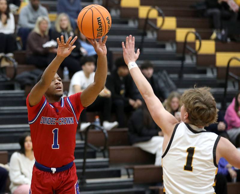Dundee-Crown's Kadin Malone shoots the ball over Jacobs' Jack Magee during a Fox Valley Conference boys basketball game on Tuesday, February. 3, 2026, at Jacobs High School in Algonquin.