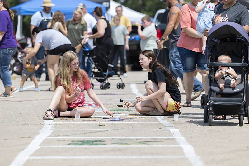 Chloe Zais (left), 15, and Eliana Crow, 15, of Tampico paint the town Sunday, July 21, 2024 during Tampico Days.