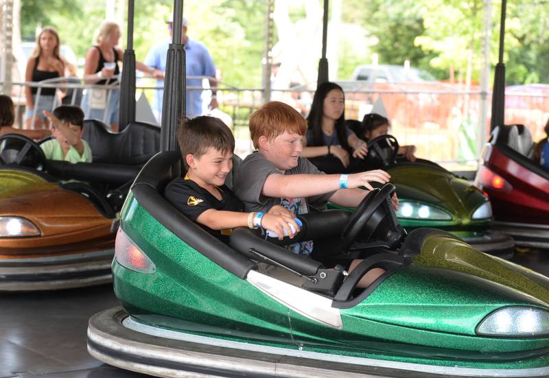 (left) Gavin and Aiden Brown of Springfield Missouri enjoy the bumper cars during the Taste of Westmont Saturday July 12, 2025.
